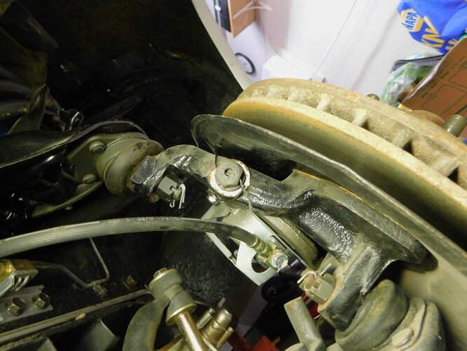 Chris B 57 brake caliper bracket safety wire installed.jpg
